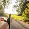 Person hält Teleskop Nordic Walking Stöcke aus Aluminium von Alpin Loacker, ideal für Outdoor-Aktivitäten. Ergonomische Griffe und verstellbare Länge sind sichtbar.