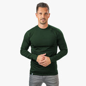 Mann trägt Merino Langarm Shirt Herren 150 g/m², ideal für Outdoor-Aktivitäten. Hergestellt aus atmungsaktiver, temperaturregulierender Merinowolle, perfekt für Wandern und Alltag.