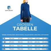 Frau in blauer Merino Jacke Damen 270 g/m², stehend vor Poster, betont Funktionalität und Komfort für Outdoor-Abenteuer.