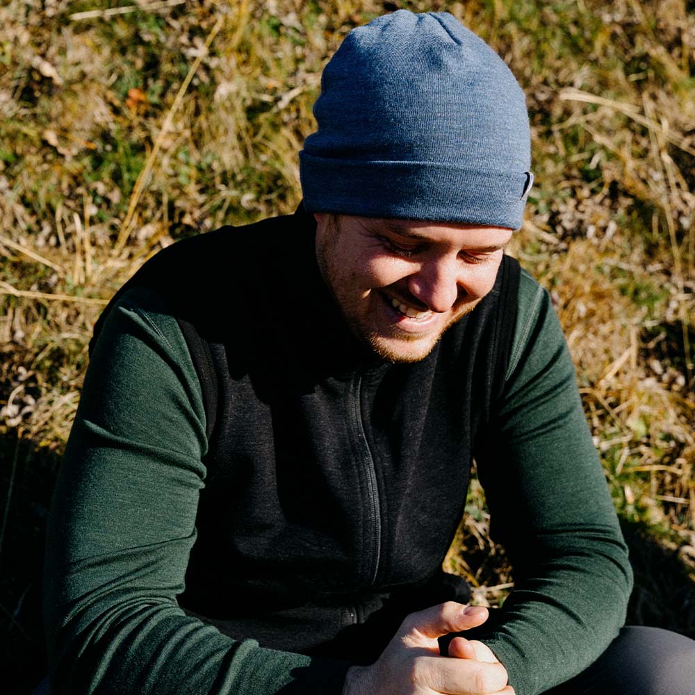 m², sitzt im Gras und lächelt, ideal für Outdoor-Aktivitäten und Alltagskomfort.