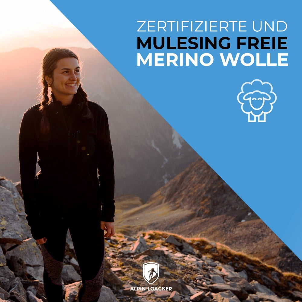 Frau auf felsigem Hügel trägt Merino Jacke Damen 270 g/m2, ideal für Outdoor-Abenteuer. Hochwertige Merinowolle bietet Komfort und Funktionalität.